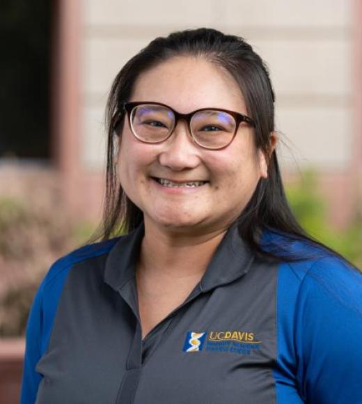 Profile picture of Teresa wearing a blue collar shirt outside a building