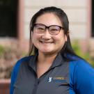 Profile picture of Teresa wearing a blue collar shirt outside a building